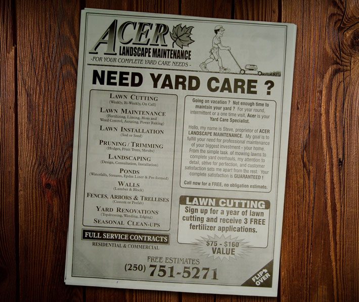 An old newspaper ad for Acer Landscaping sitting on a rich wooden background