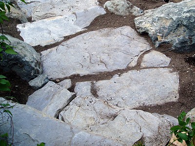 Detail view of a pathway and stairs built using natural stone quarried in British Columbia for landscaping use