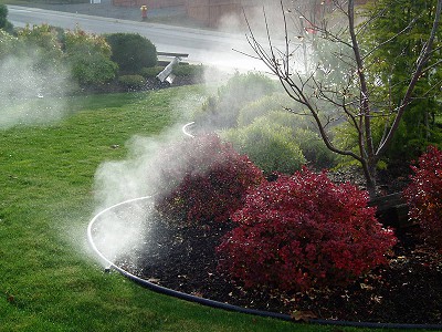 View of underground sprinklers being blown out for Winter by Acer Landscaping