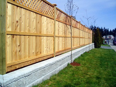 Wooden panel fence built by Acer Landscaping on a short concrete retaining wall