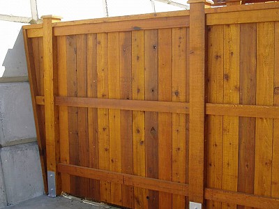 Large custom cedar wood fence built in an industrial compound by Acer Landscaping